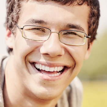 young man in glasses with a beautiful smile